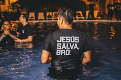 man wearing black t-shirt standing in pool