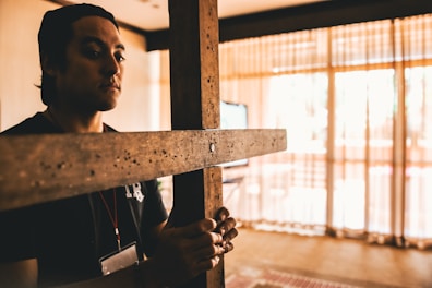 A lamp decorated with Christian cross motifs, casting a soft light on a wooden table.
