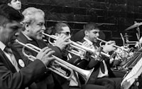 greyscale photo of trumpet players playing