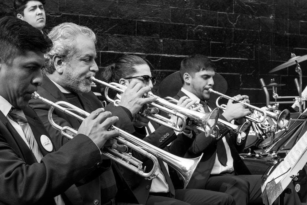 greyscale photo of trumpet players playing