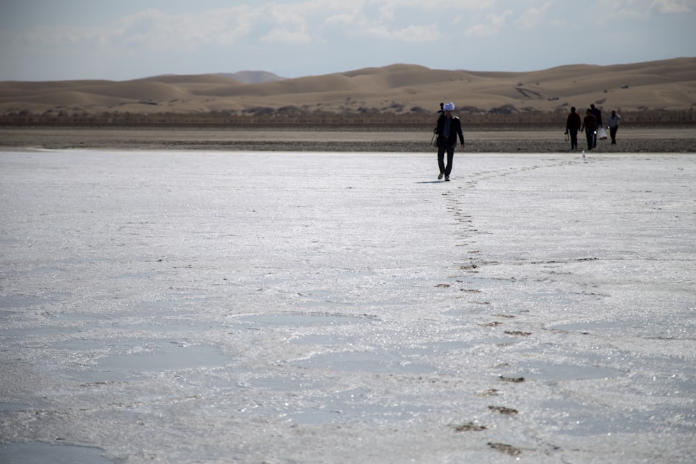 people walking on wet soil