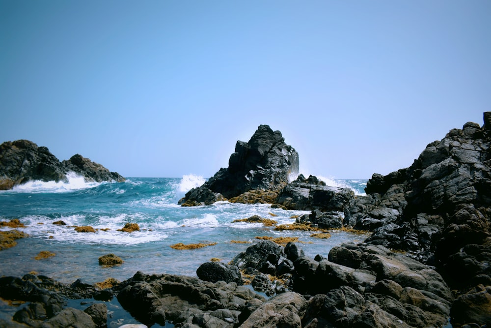 brown rocks and body of water