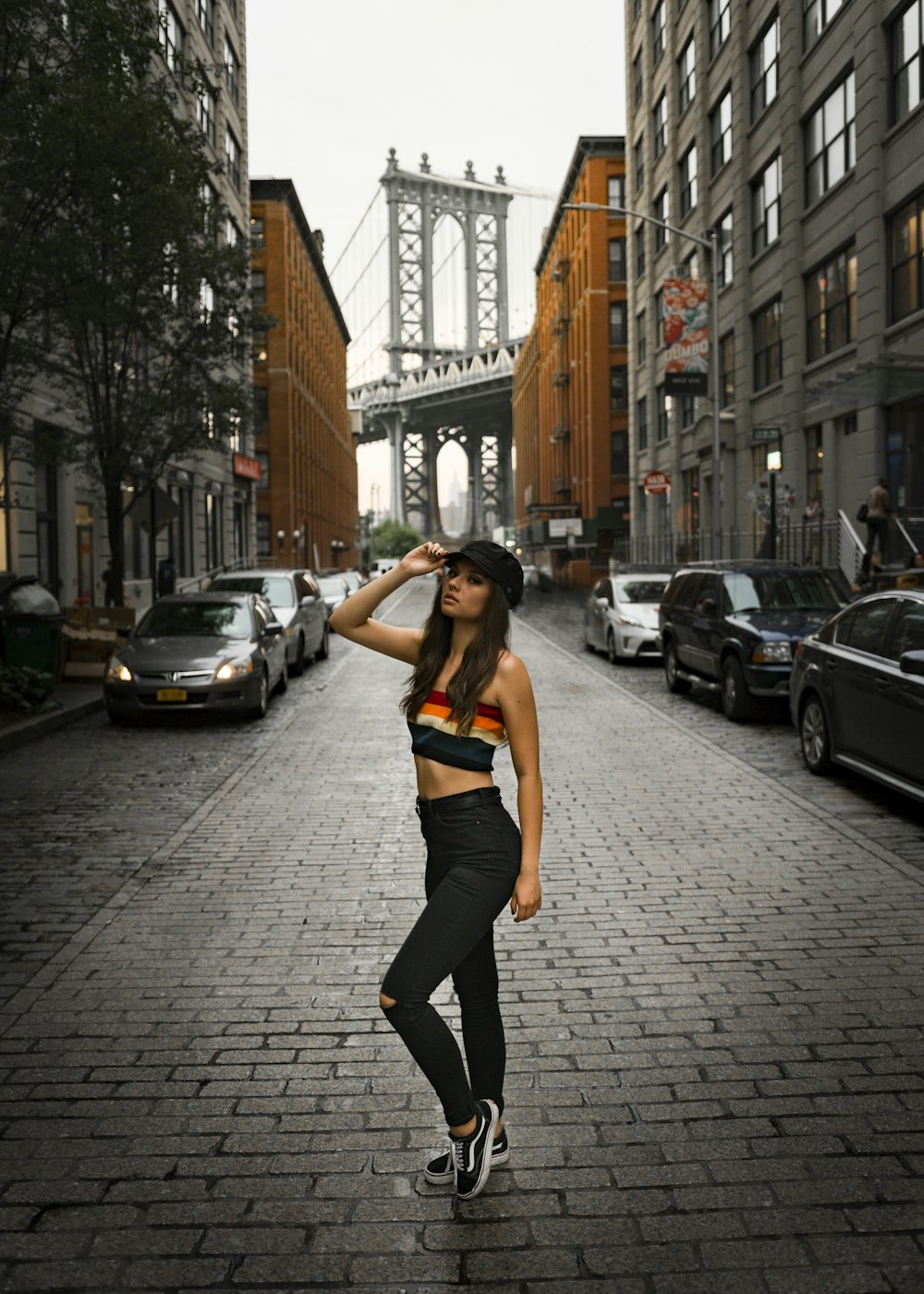 woman standing on road and putting hand on her head