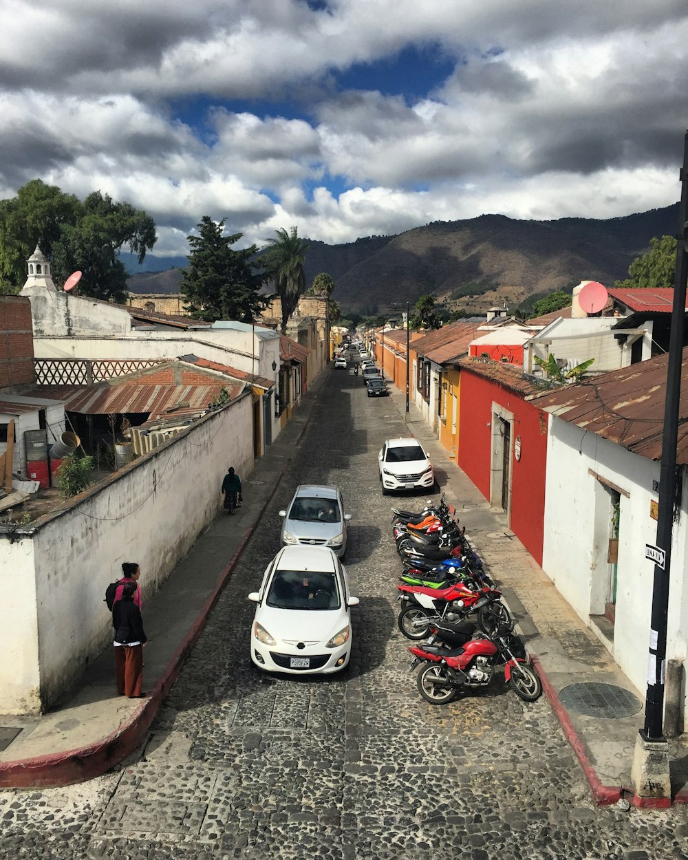 vehicle and motorcycle in road during daytime