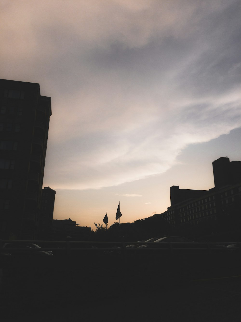 silhouette of building and vehicles