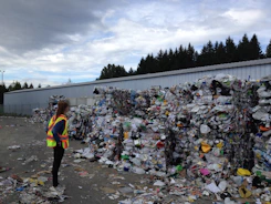 woman standing in front garbage