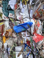 blue plastic bottle on top of garbage