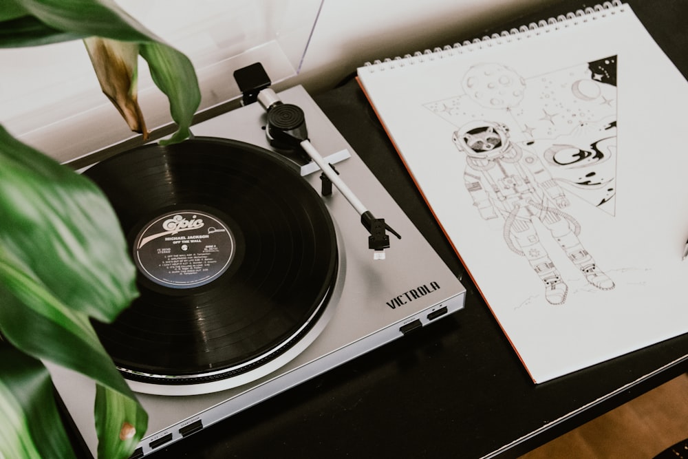 turntable beside sketchpad with astronaut drawing