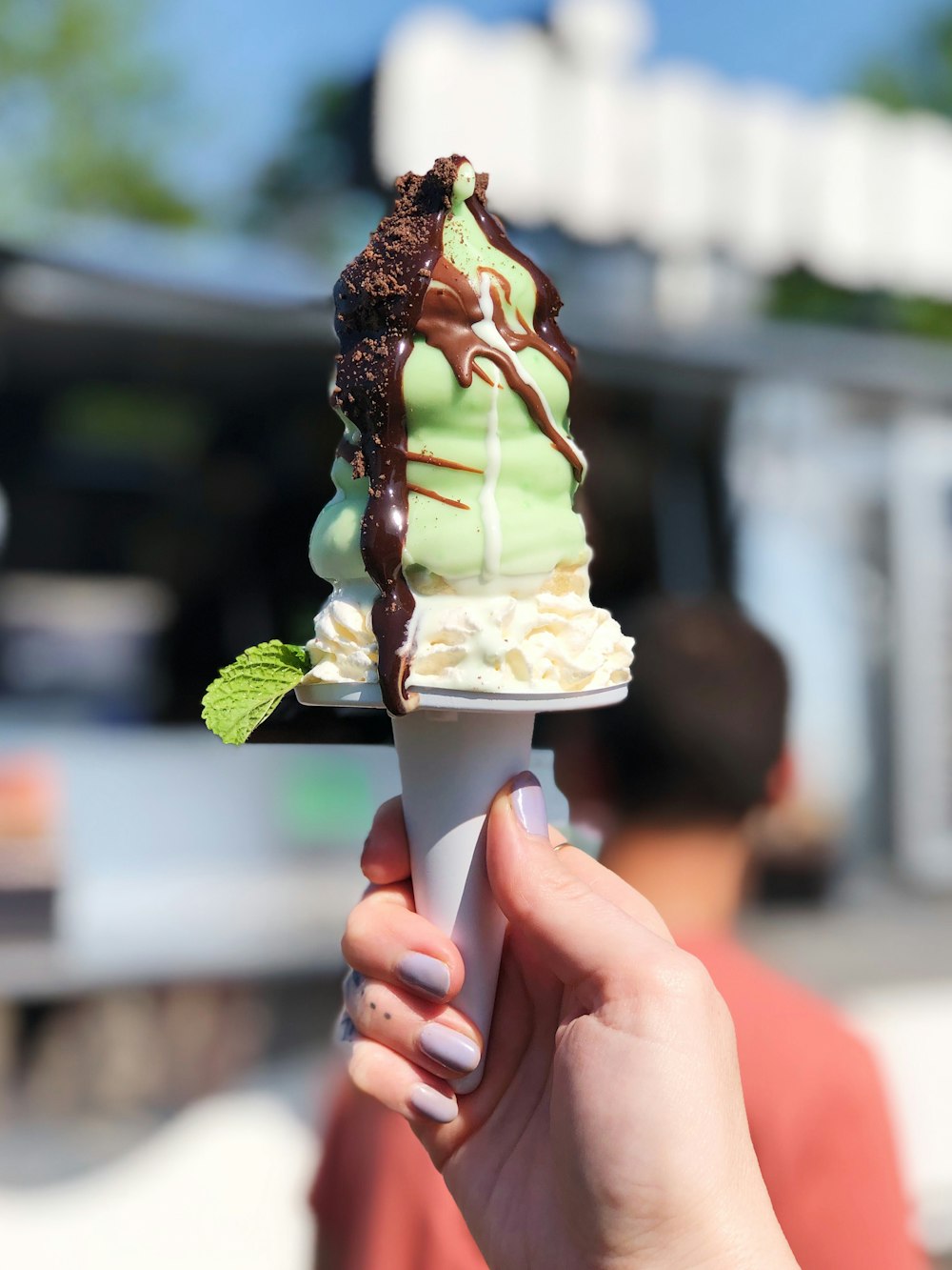 green ice cream coated with chocolate syrup