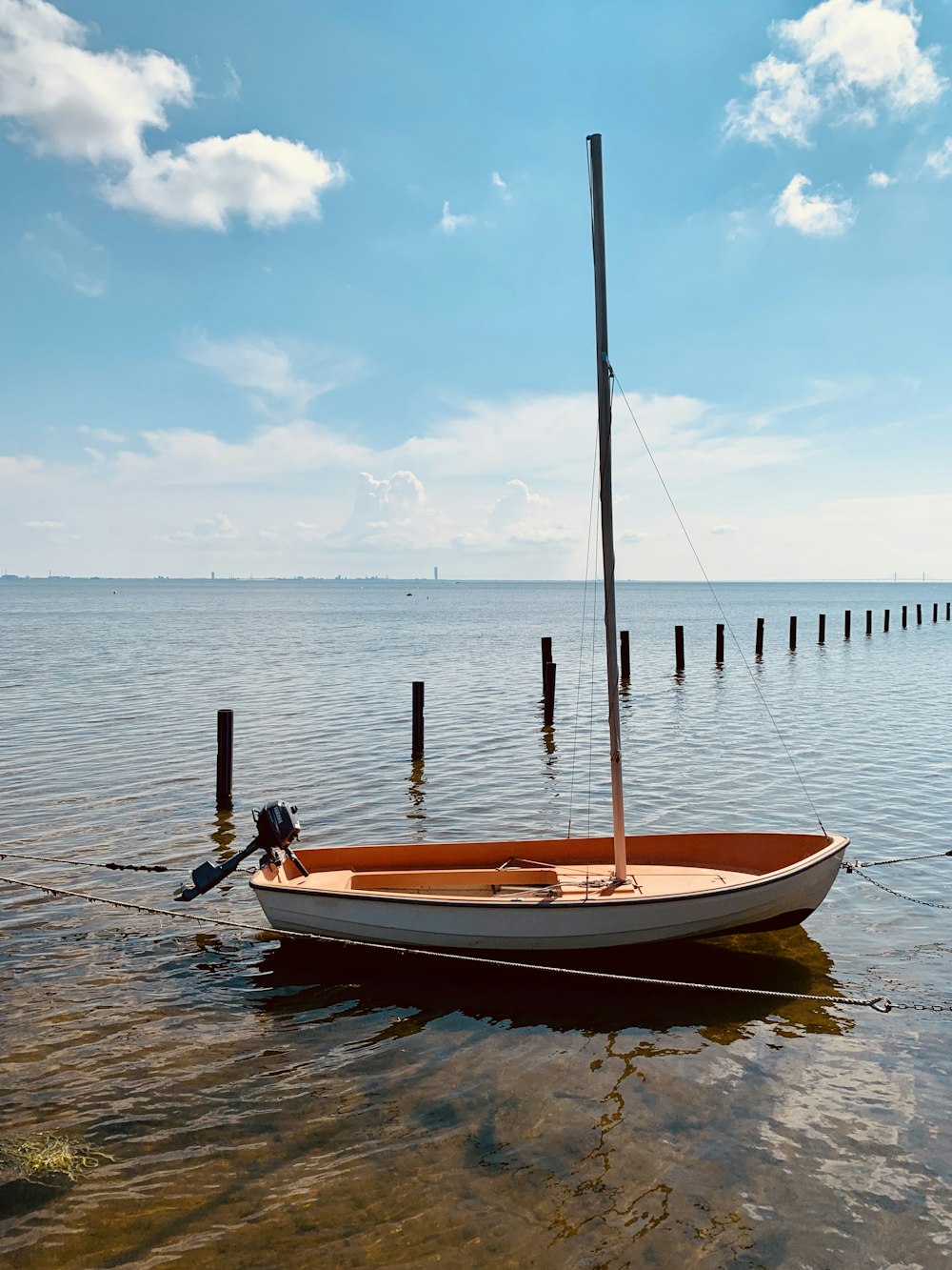 brown and white boat on body of water