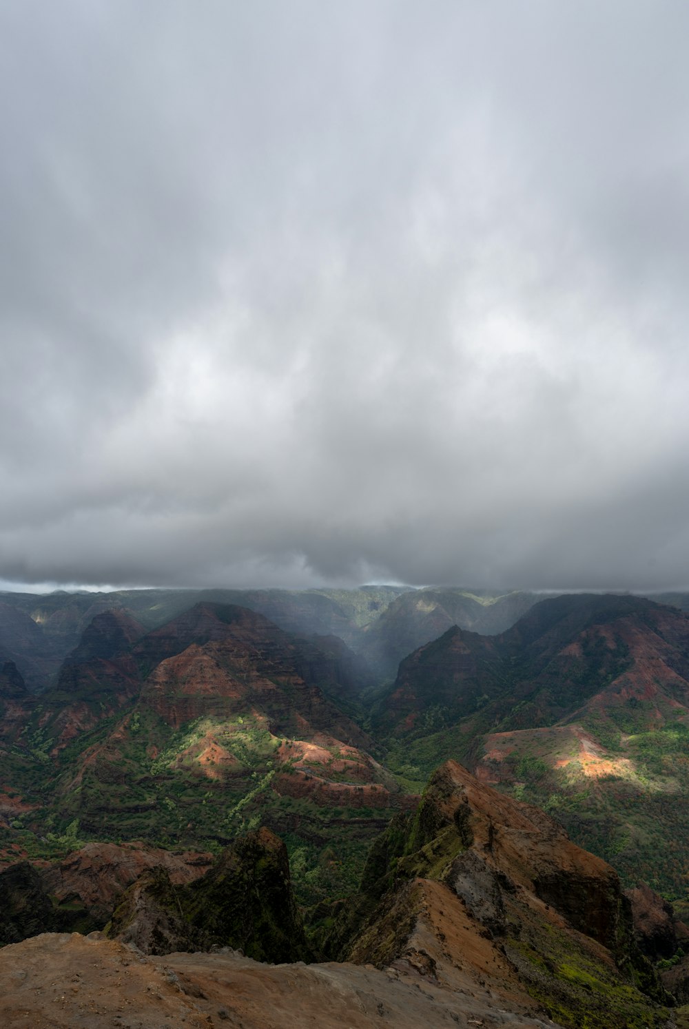 brown mountain under white clouds