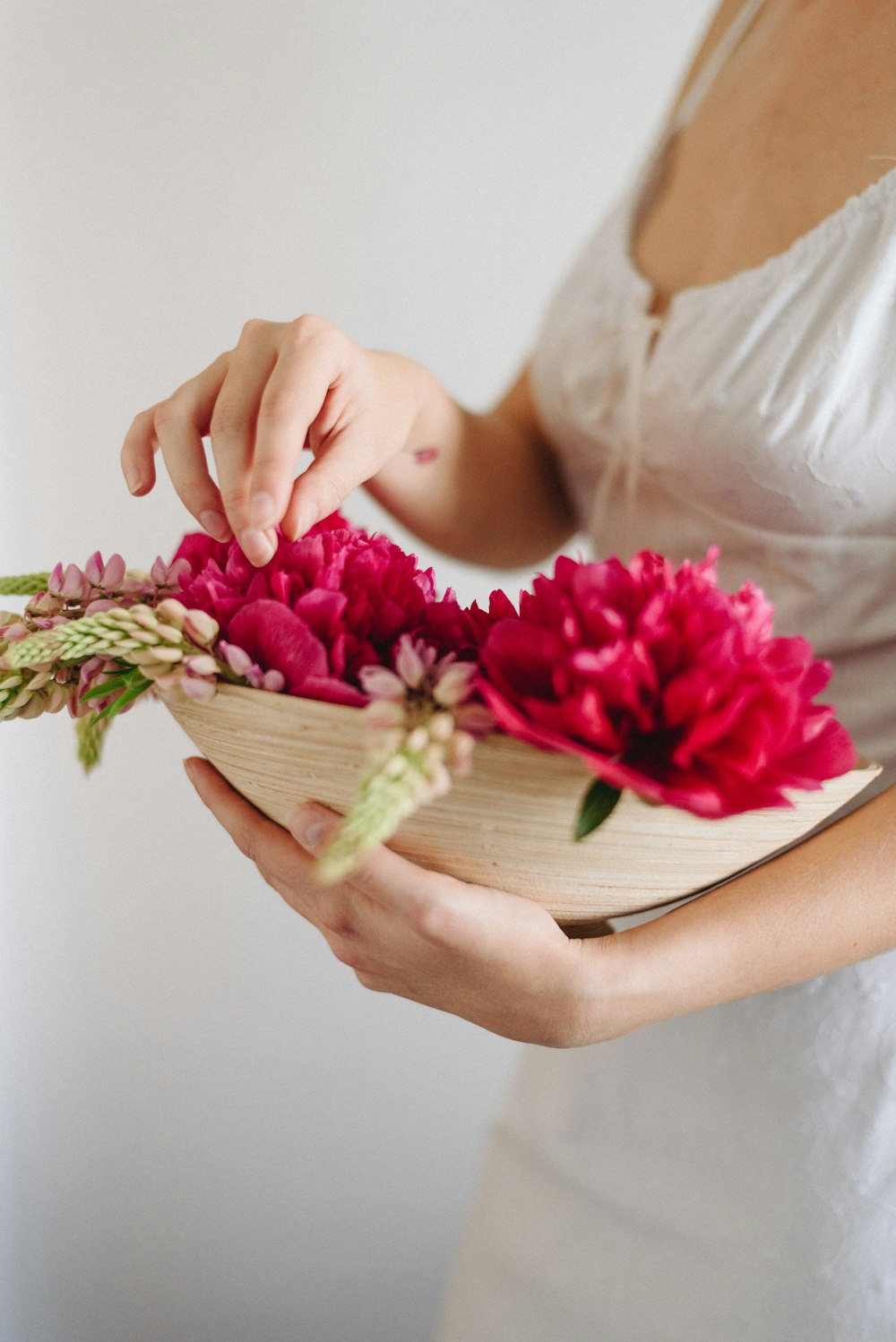 woman carrying basket of flowers