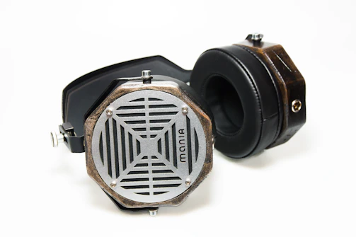 Retro-inspired headphones with a leather headband displayed on a vintage record player.