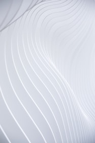 a close up of a white wall with wavy lines