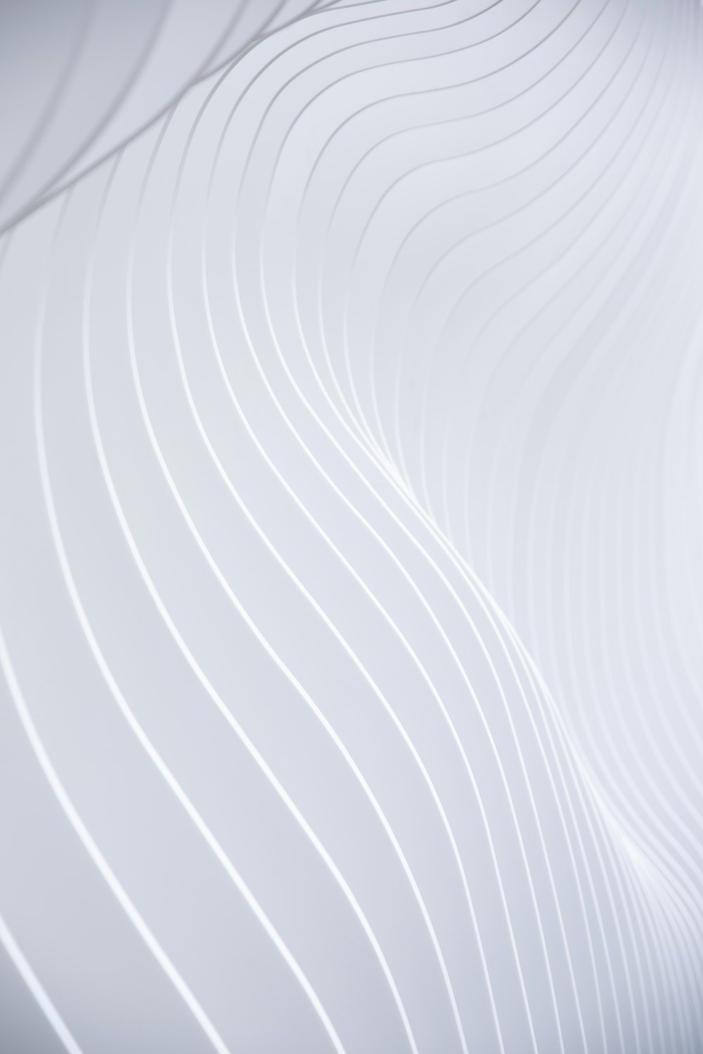 a close up of a white wall with wavy lines