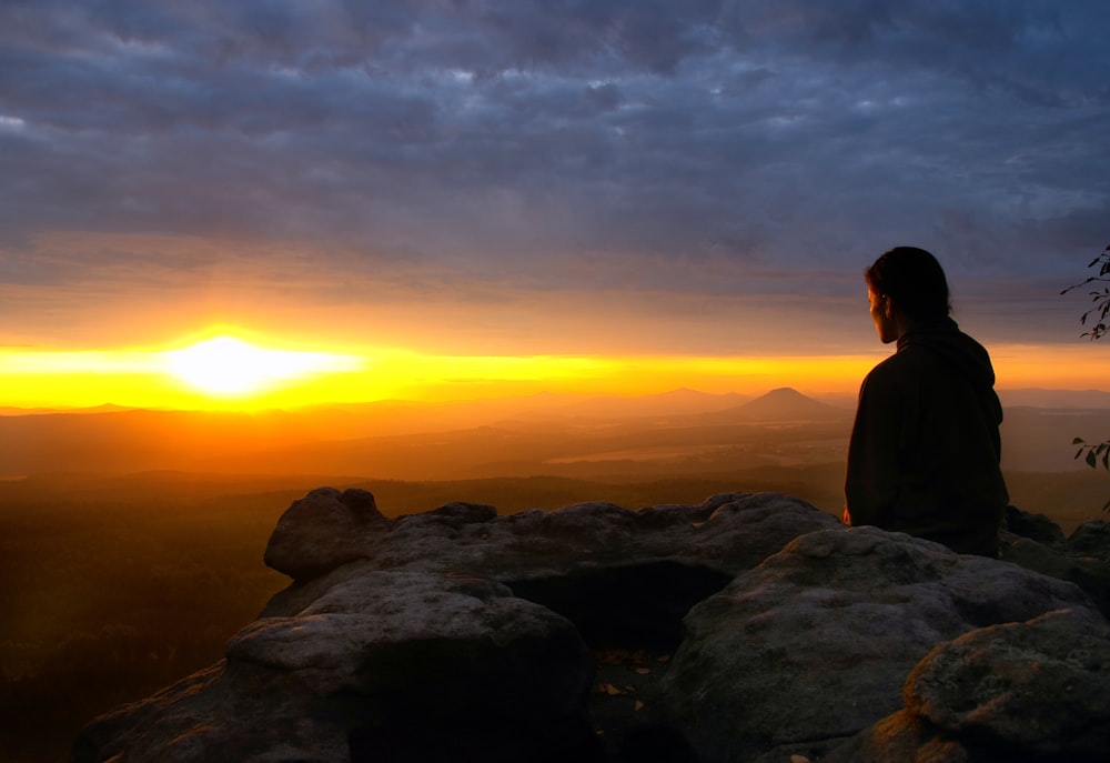 silhouette of sitting woman during golden hour