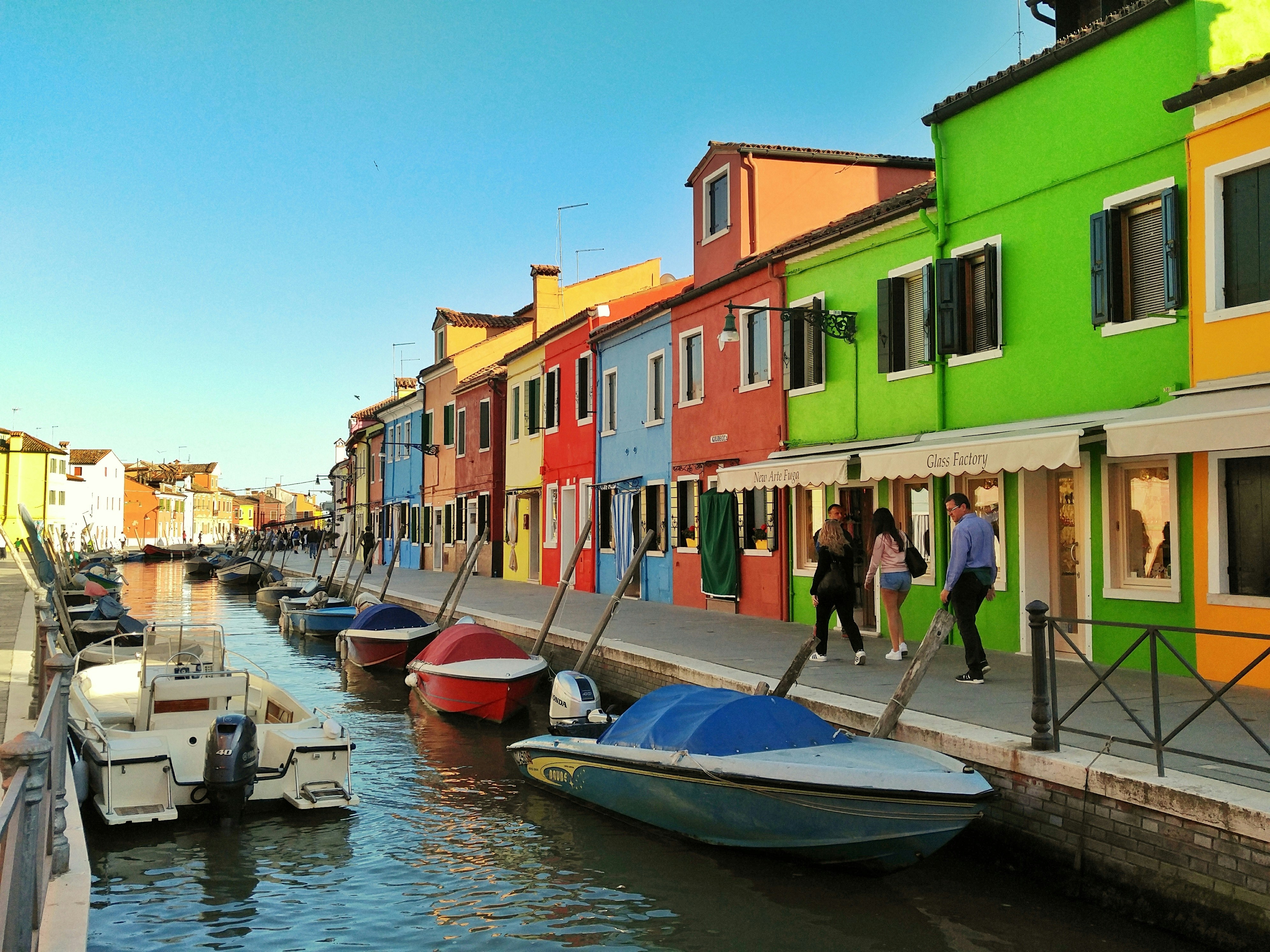 motorboats parked beside multicolored houses
