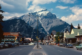 cars parked beside road near mountain