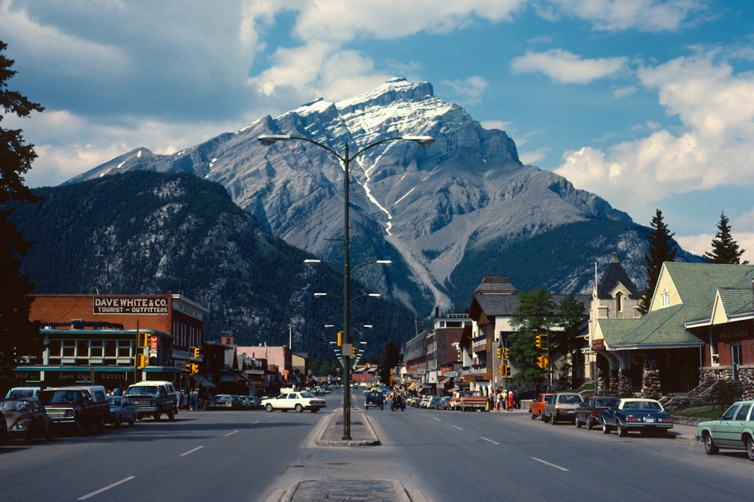 cars parked beside road near mountain, My father took this picture over 40 years ago. He was living in Canada after emig