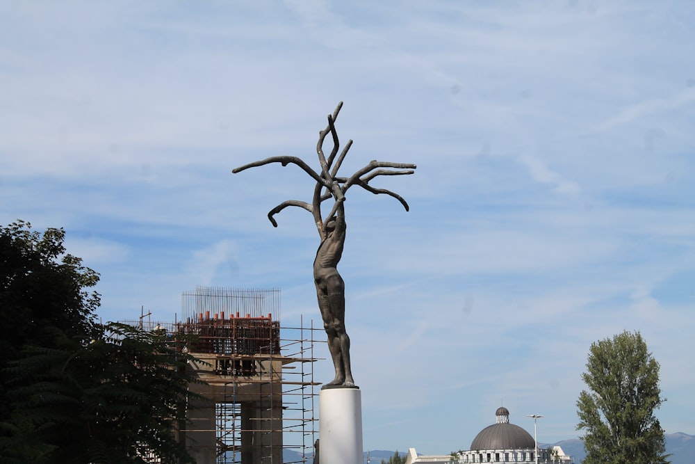 standing person statue during daytime