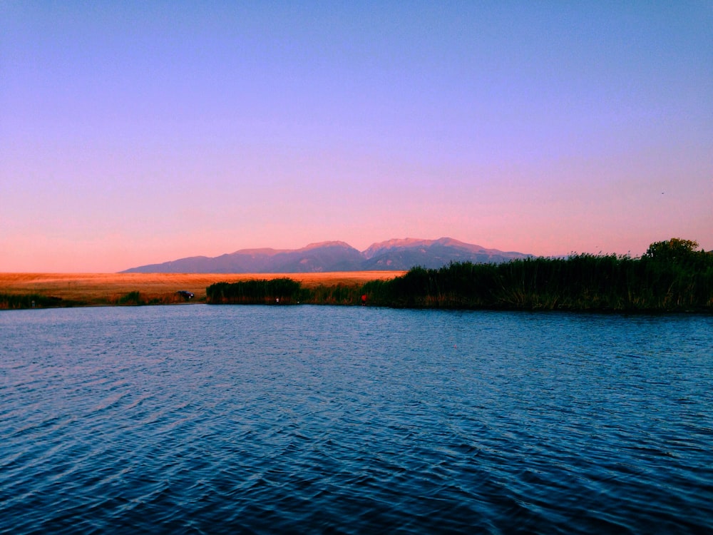 calm body of water during golden hour