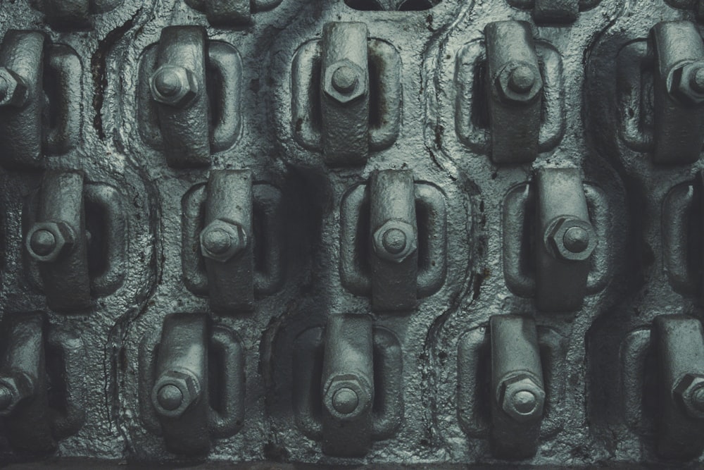 a close up of a wall made of metal pipes