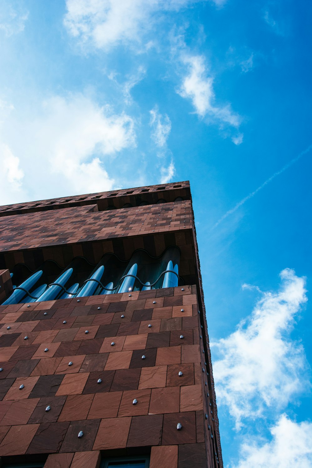 low-angle photo of brown building under blue sky