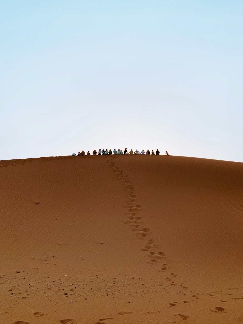 people standing on hill during daytime