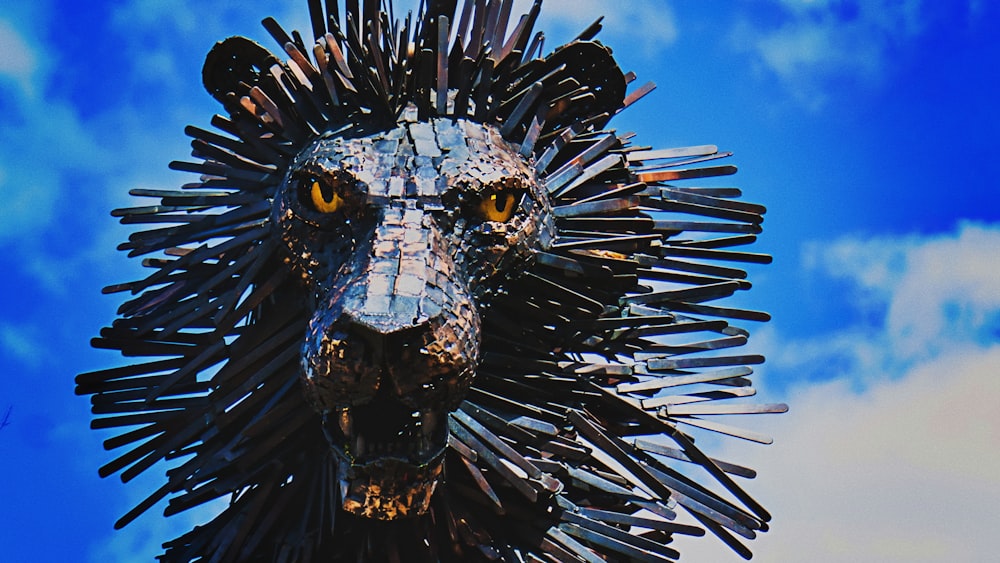 brown wooden lion decor under white and blue skies