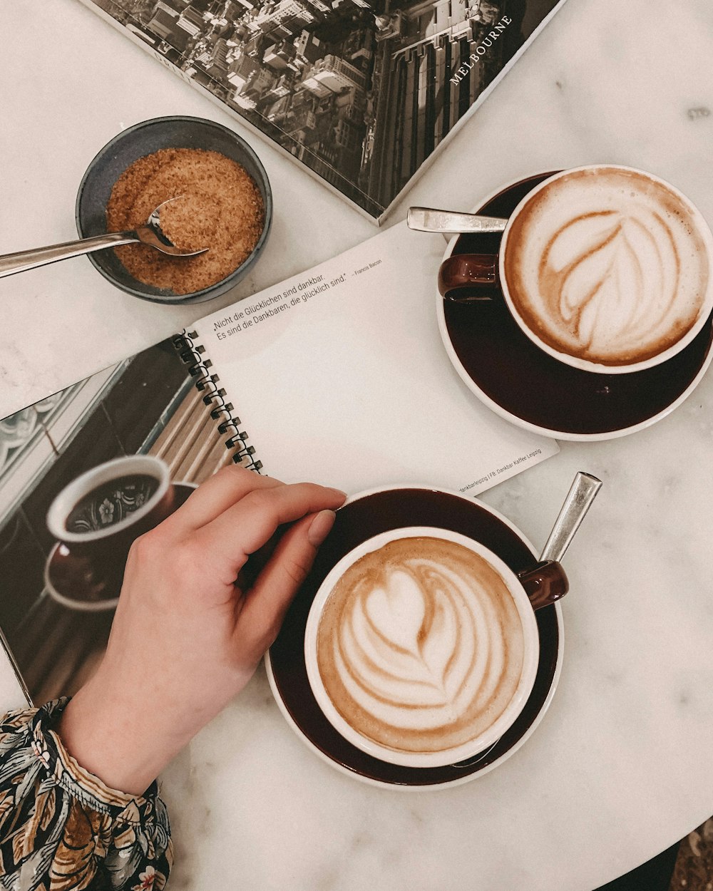 white ceramic cup with cappuccino on black ceramic saucer