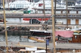 An aerial view of multiple ships docked side by side in a sprawling harbor.