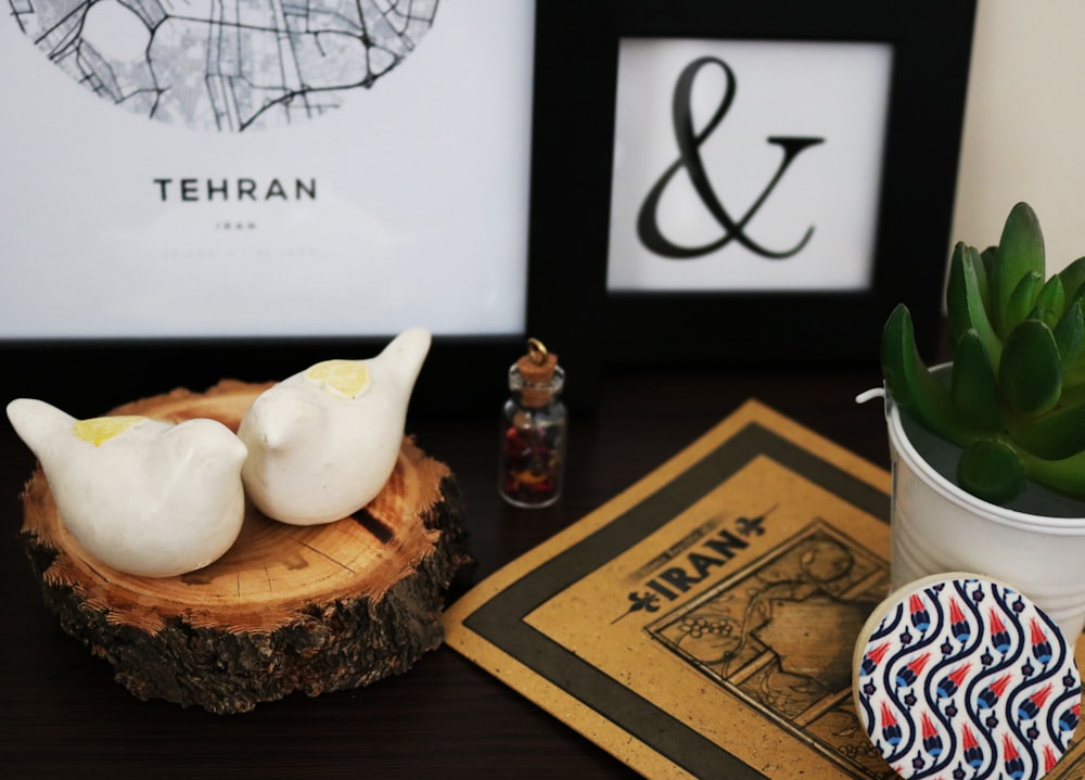 two white ceramic bird figurines