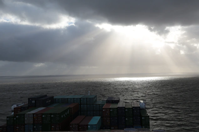 A global map with shipping routes and containers symbolizing international trade.