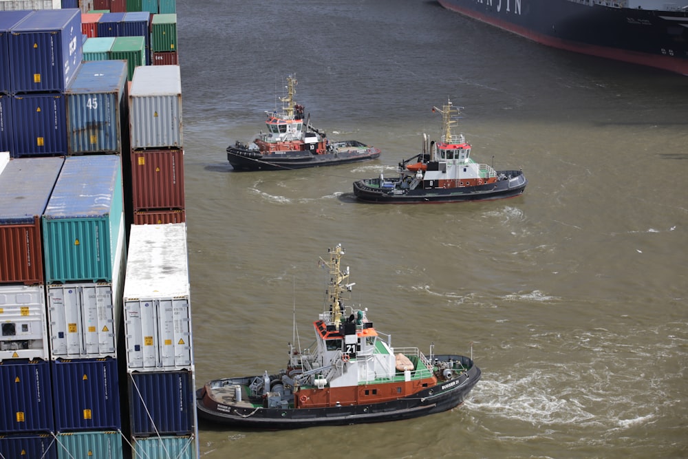 cargo ships in front of piled intermodal containers