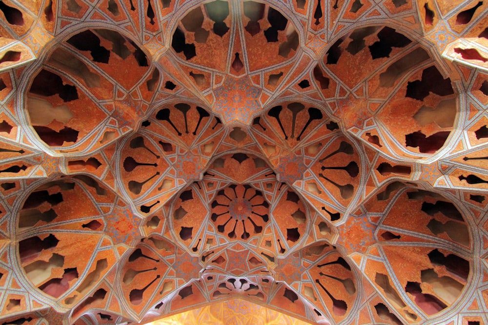 low-angle photography of orange and black geometric ceiling