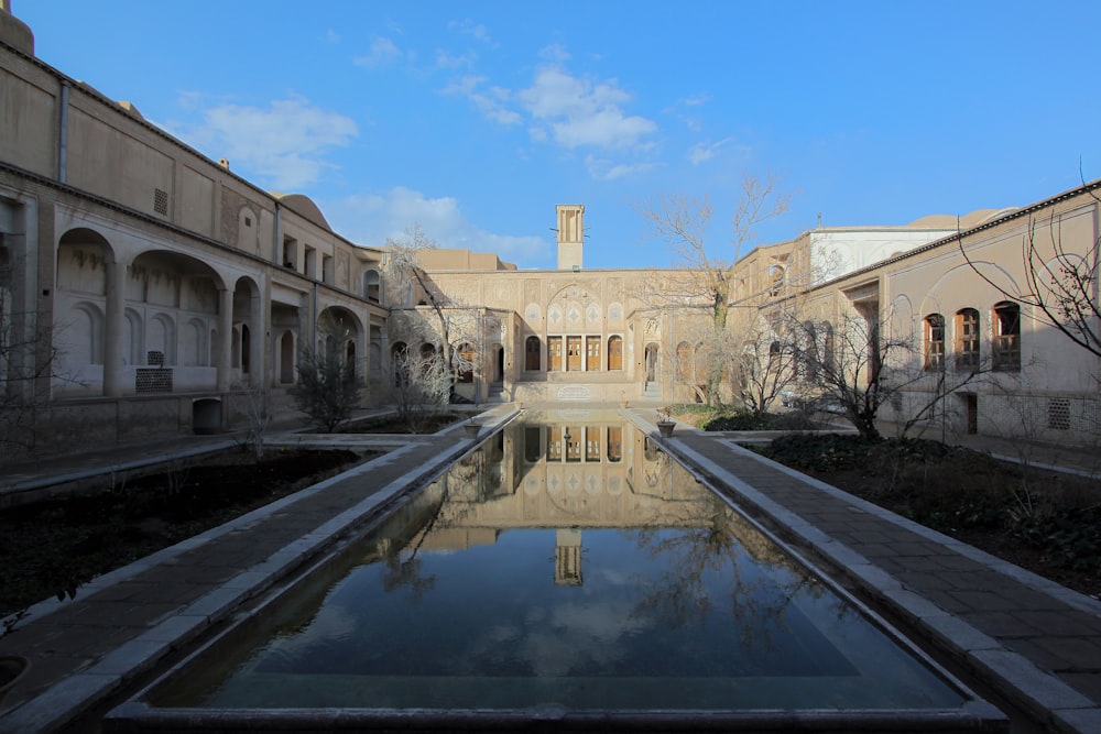 pond in grey concrete building during daytime