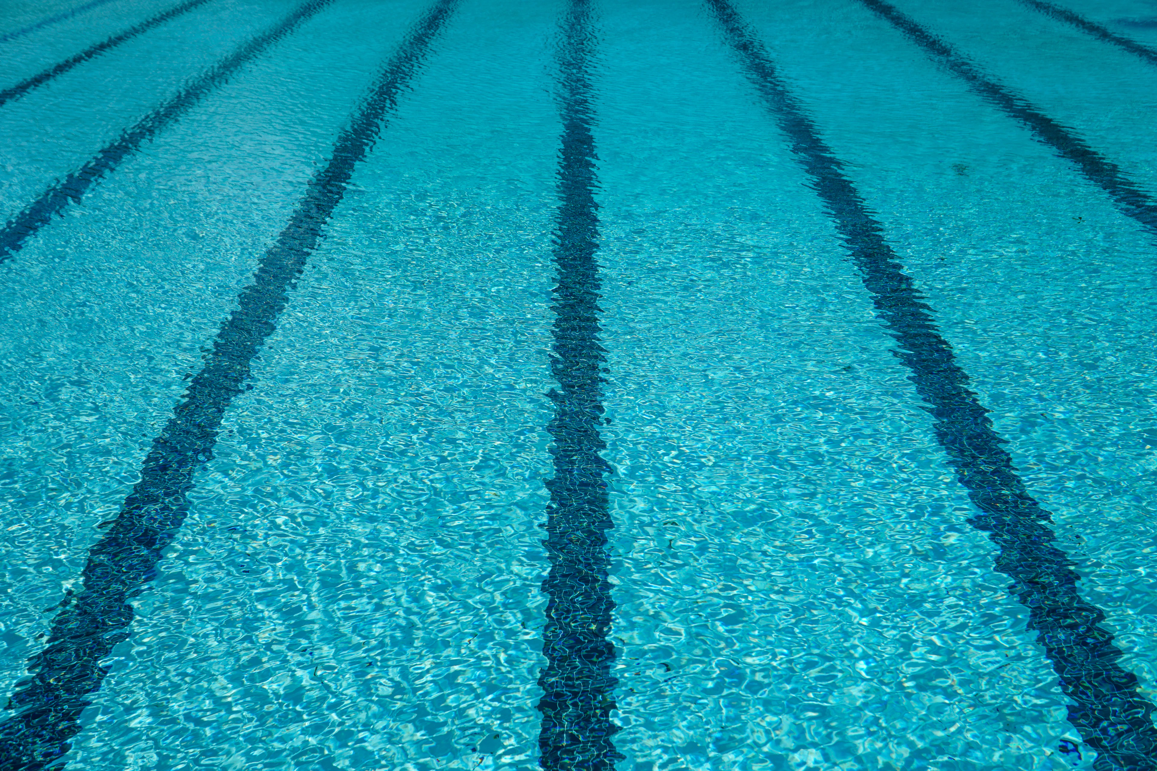 Close-up of tiled swimming pool edge with water