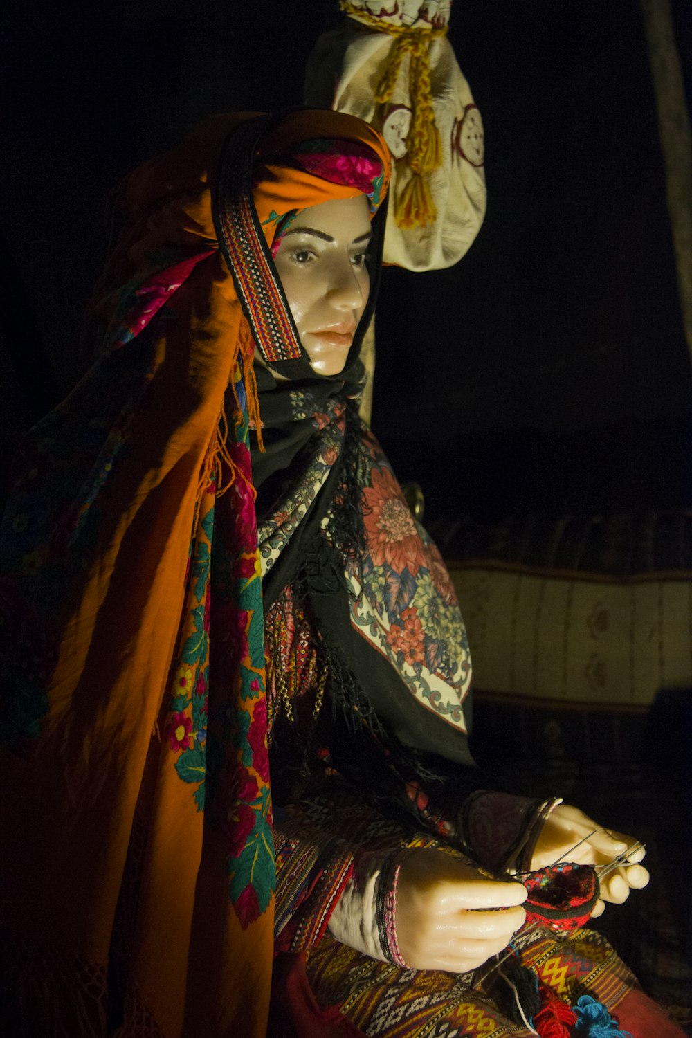 woman wearing orange and green floral hijab