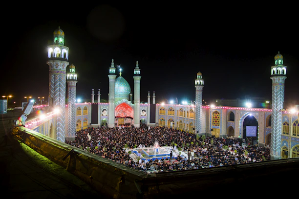 A vibrant crowd at a twilight qawwali gathering, bathed in warm amber light.