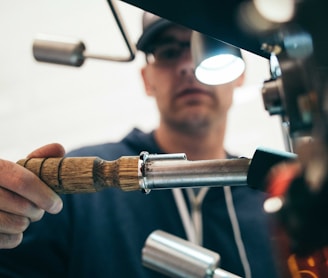 man wearing black pullover hoodie holding tool