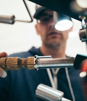 man wearing black pullover hoodie holding tool