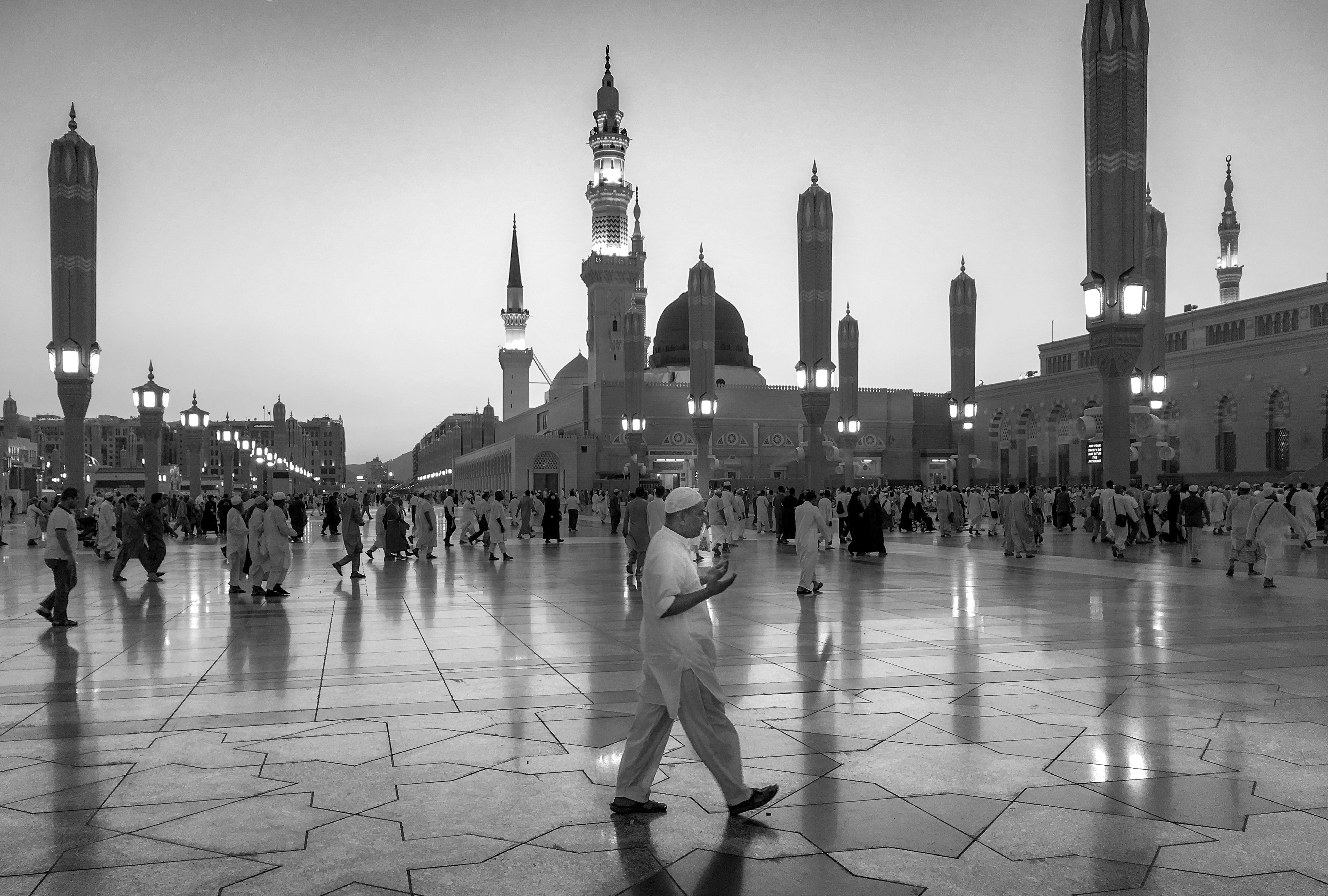 Hope This was a scene in the courtyard of Masjid An-nabawi in Medina. A call of Maghrib prayer was made and I spotted a man walking and responding the the call of prayer by making supplications.