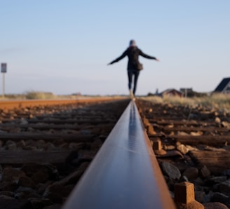 woman walking on train railway