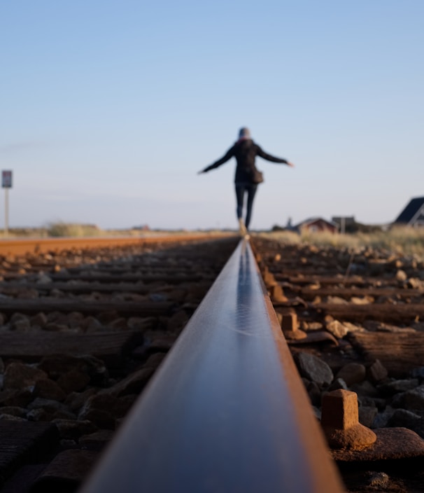 woman walking on train railway