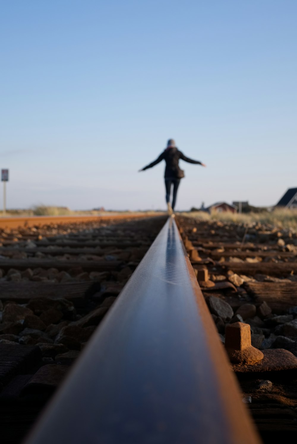 woman walking on train railway