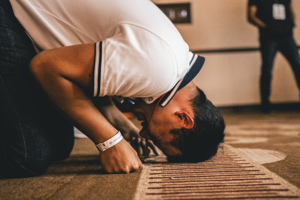 a man is bending over on the floor