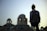 A smiling traveler standing in front of the Dome of the Rock at sunset.