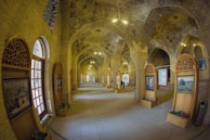 An elegant hallway in a boutique inn decorated with colorful textile art.
