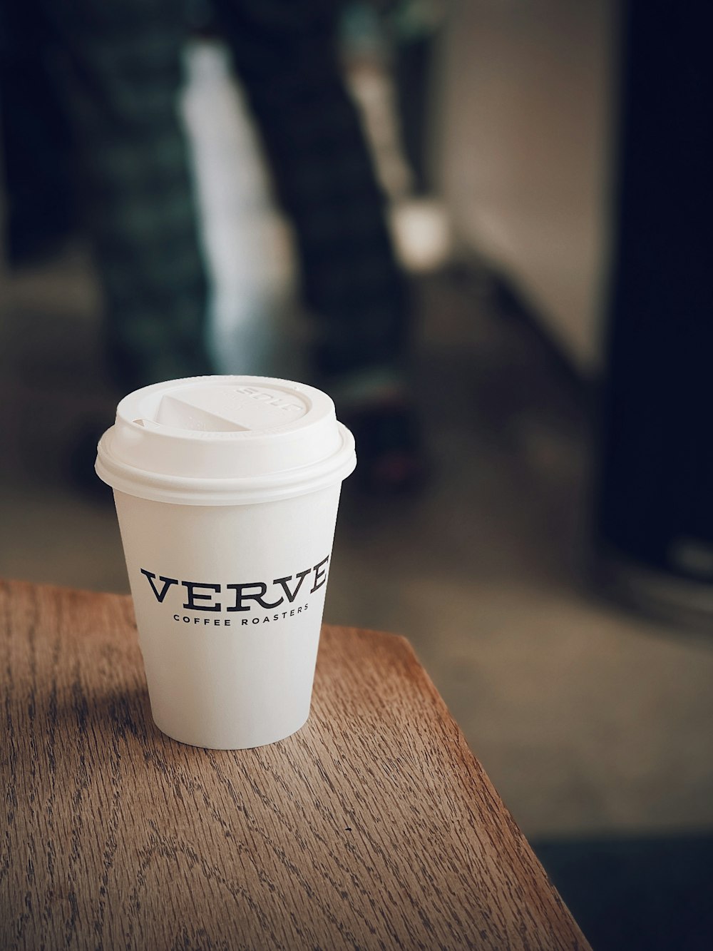 white Verve disposable cup on table edge