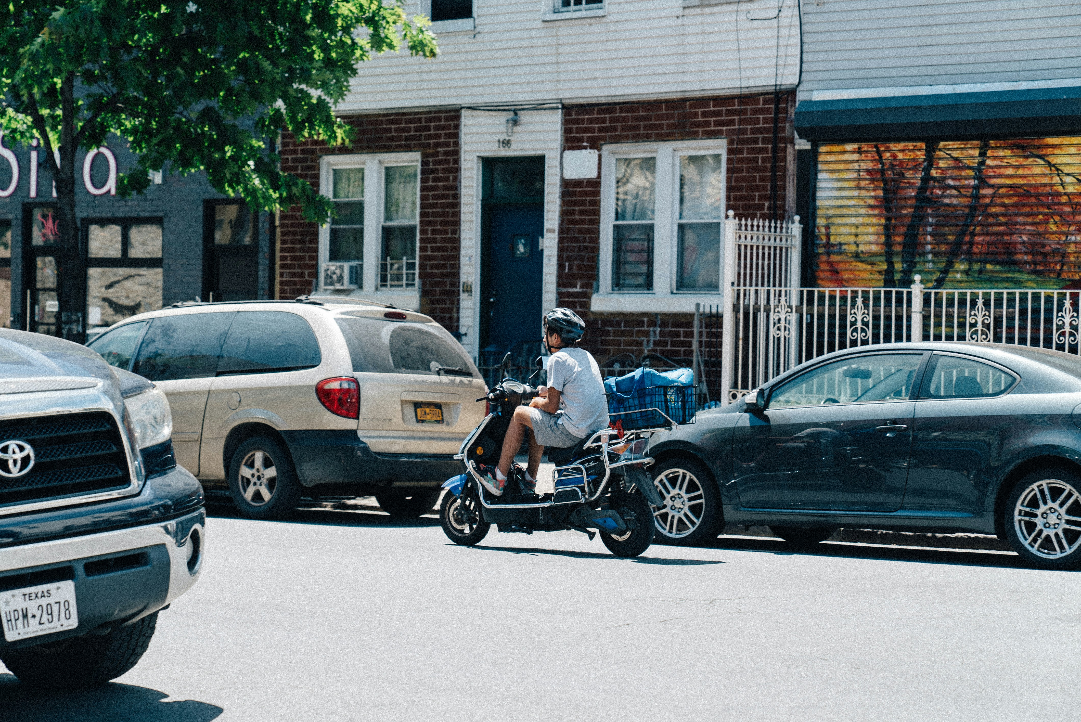 man riding scooter on road during daytime